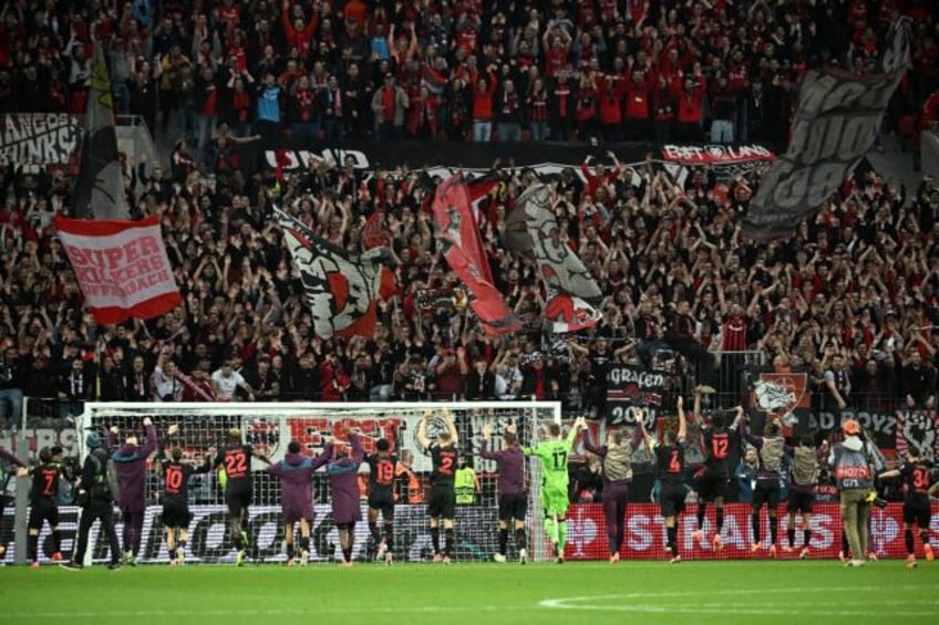 Bayer Leverkusen's players celebrate with fans after their Europa League quarter-final fir