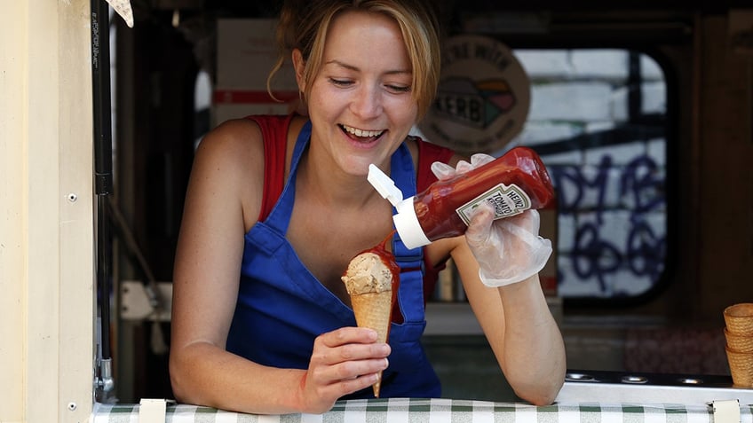 Woman pours ketchup