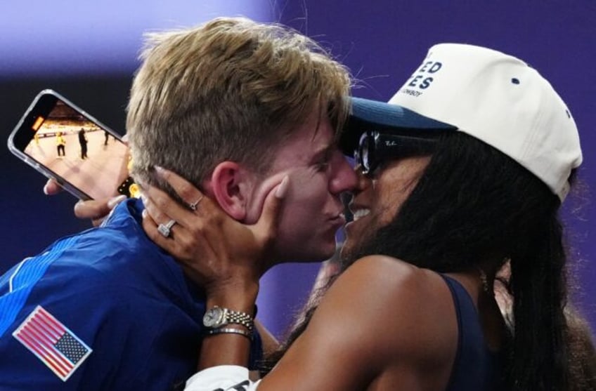 Hunter Woodhall gets a kiss from his wife, Olympic women's long jump champion Tara Davis-W