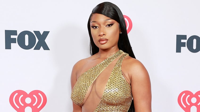 Megan Thee Stallion wears gold glitter dress on red carpet at awards show