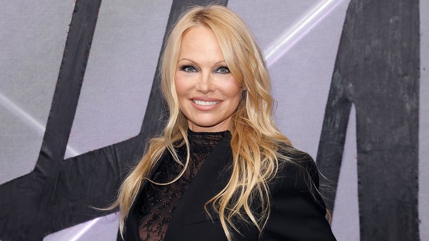 Pamela Anderson smiling at an event in 2023