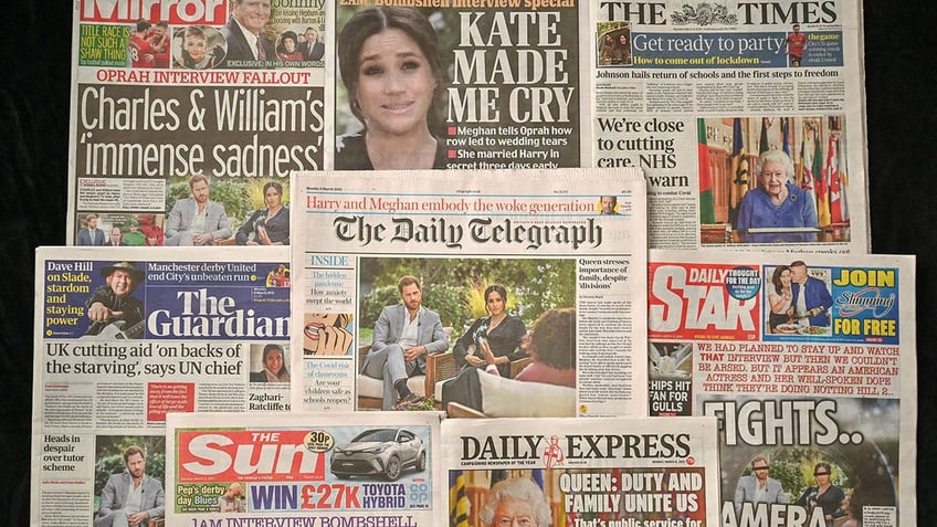 Stacks of English newspapers reporting on Meghan Markle's interview with Oprah Winfrey.