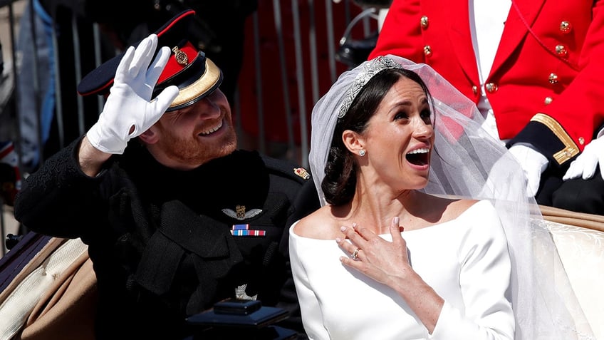 Britainâs Prince Harry and his wife Meghan ride a horse-drawn carriage after their wedding ceremony at St Georgeâs Chapel in Windsor Castle in Windsor, Britain, May 19, 2018. Benoit Tessier: "After installing my equipment, I had a long wait before seeing the couple. After six hours, they finally passed by. Meghan seemed very excited." REUTERS/Benoit Tessier/File photo SEARCH "WEDDING PHOTOGRAPHS" FOR THIS STORY. SEARCH "WIDER IMAGE" FOR ALL STORIES. TPX IMAGES OF THE DAY - RC1B0322B330