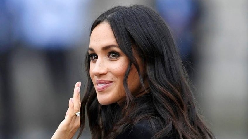 Meghan, Duchess of Sussex, waves as she visits Trinity college, in Dublin, Ireland, Wednesday, July 11, 2018. (Joe Giddens/PA via AP)