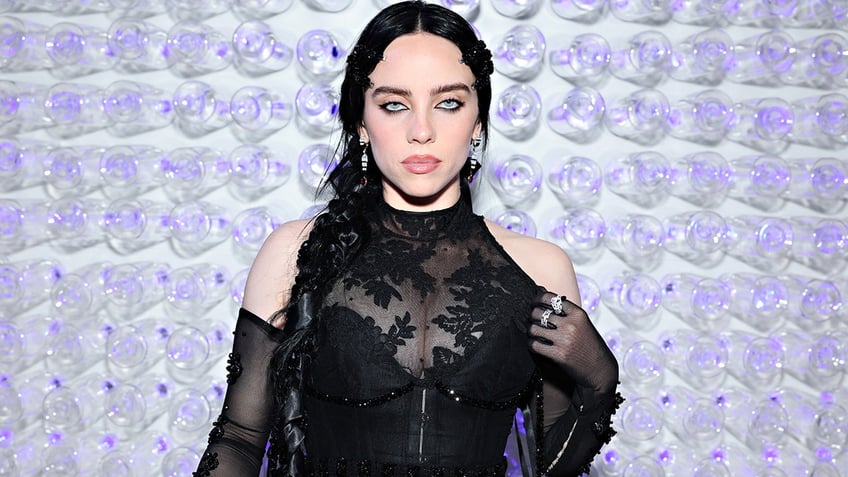 Billie Eilish wears a lace black dress at the Met Gala and stares directly at the camera