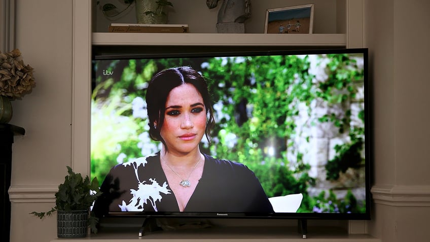 A close-up of Meghan Markle on television talking to Oprah Winfrey