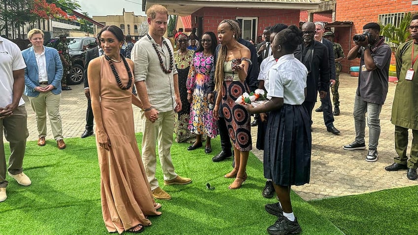 Prince Harry and Meghan are feted in a school in Nigeria