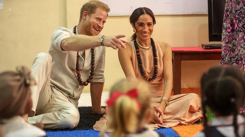 Prince Harry and Meghan are feted in a school in Nigeria