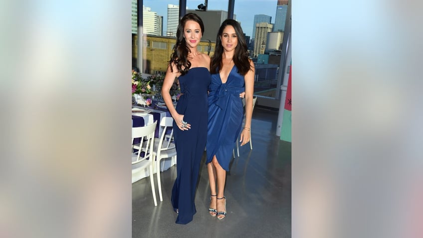 Meghan Markle and Jessica Mulroney posing together in blue outfits