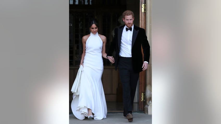 Meghan Markle and Prince Harry stepping outside after they just got married