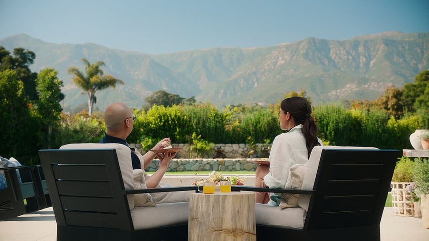 Meghan Markle and her friend Daniel Martin with their backs turned looking at the California mountains.