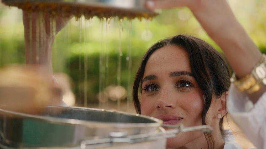 A close-up of Meghan Markle working outdoors.