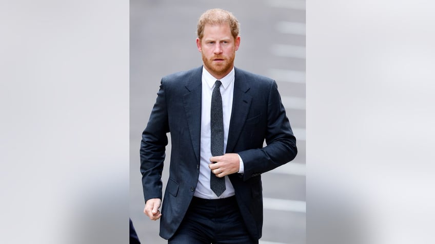 Prince Harry in a navy suit and tie