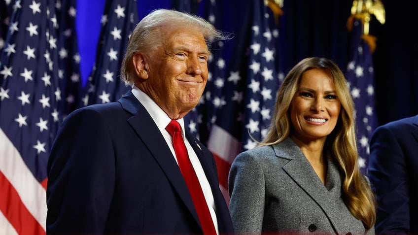 Donald Trump smiling with wife Melania to his left