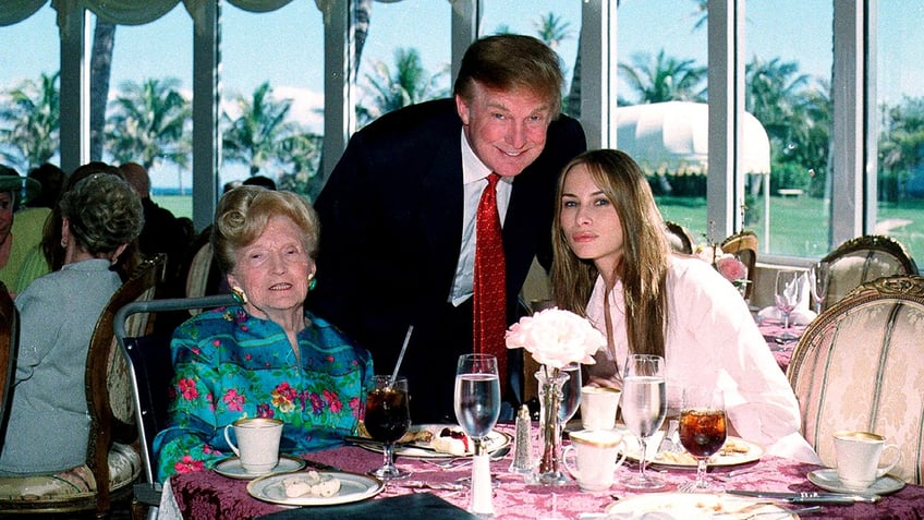 Portrait of, from left, American socialite Mary Trump, her son, real estate developer Donald Trump, and his girlfriend (and future wife), former model Melania Knauss, as they pose together in the tea house of the Mar-a-Lago club, Palm Beach, Florida, February 27, 2000. 