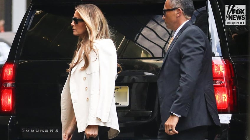 Melania Trump looking fashionable as she walks into Trump Tower flanked by security