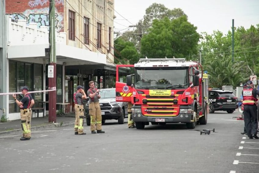 Fire fighters gather at the scene of a fire at the Adass Israel Synagogue in Melbourne on