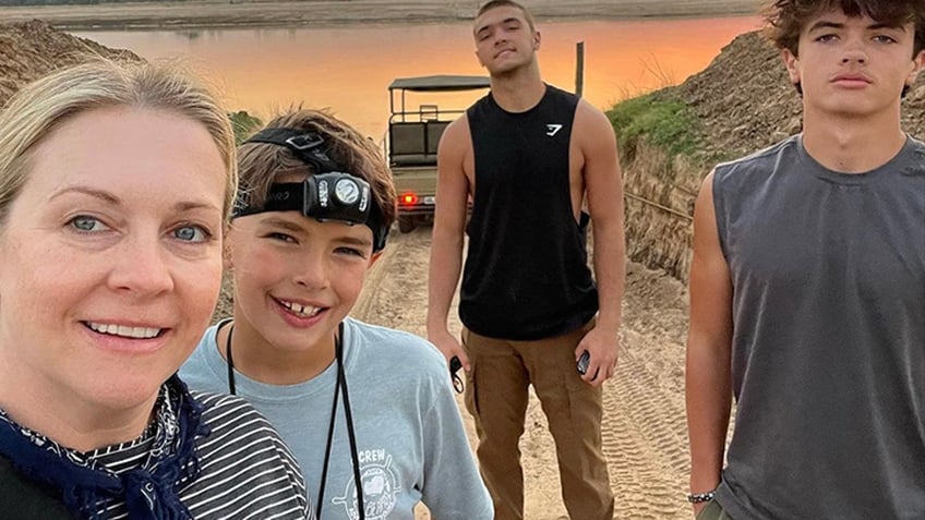 Melissa Joan hart shares a selfie with her three sons in Zambia with a beautiful sunset in the background