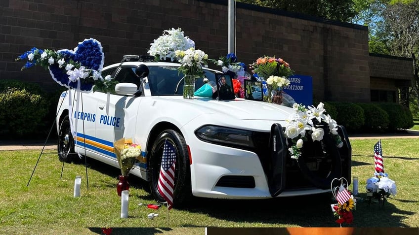 Memphis police officer Joseph McKinney's car is covered with flowers