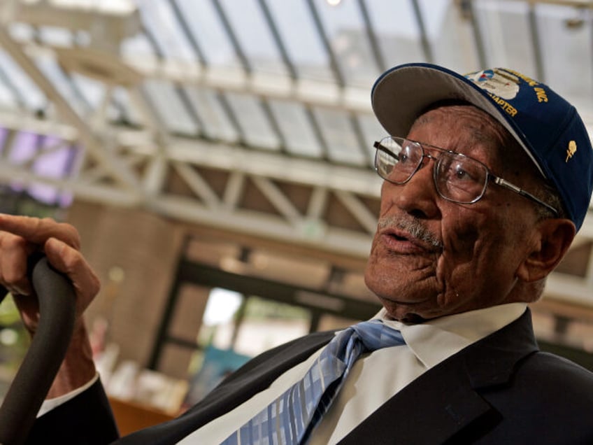 Jerry T. Hodges (Cq), a Tuskegee airman, at California African American Museum before a pa