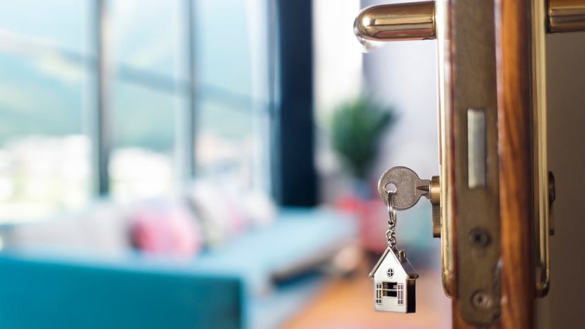 A key opening a door to a home