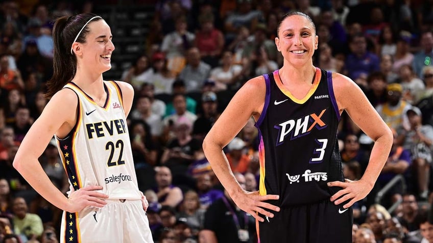 Caitlin Clark and Diana Taurasi stand on the basketball court 