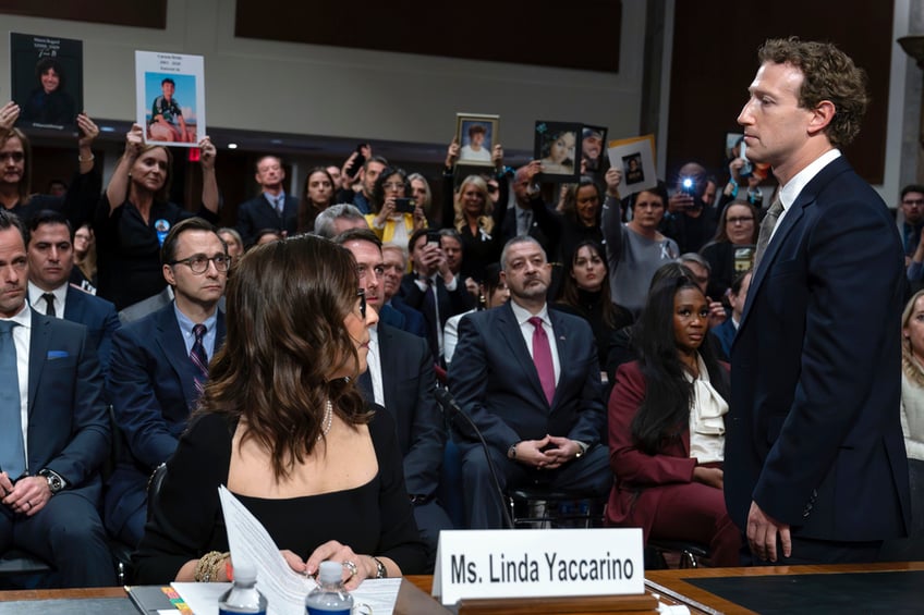 Meta CEO Mark Zuckerberg turns to address the audience during a Senate Judiciary Committee hearing on Capitol Hill in Washington, Wednesday, Jan. 31, 2024, to discuss child safety. X CEO Linda Yaccarino watches at left. (AP Photo/Jose Luis Magana)