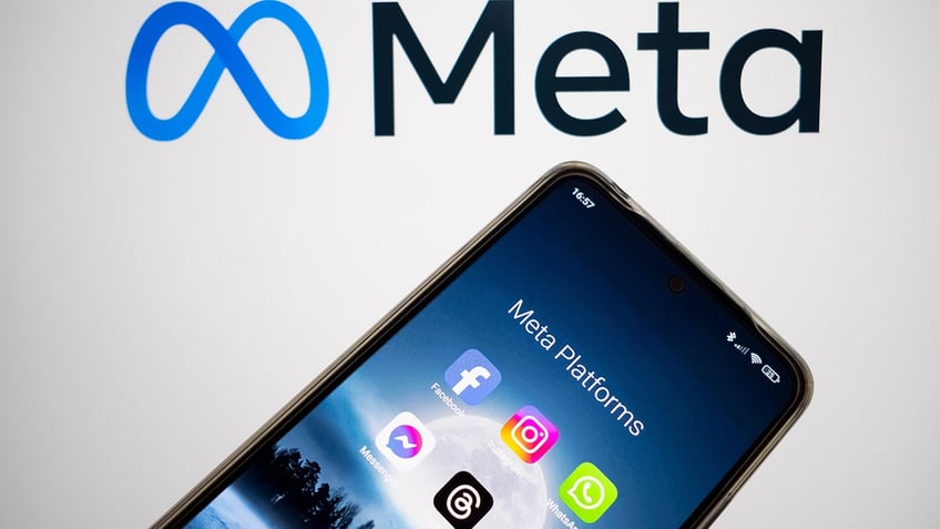 Meta logo in background with phone