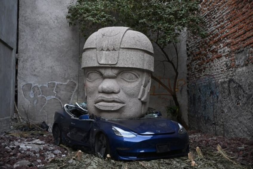 This Tesla 3 car crushed by a nine-ton Olmec-inspired head is the doing of Mexican artist