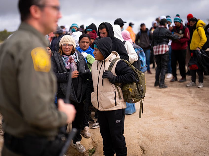 Peruvian Julia Paredes, center in white hat, listens to instructions from a Border Patrol