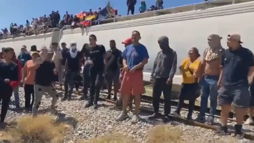 mexican train with hundreds of migrants onboard stopped passengers chant let us continue