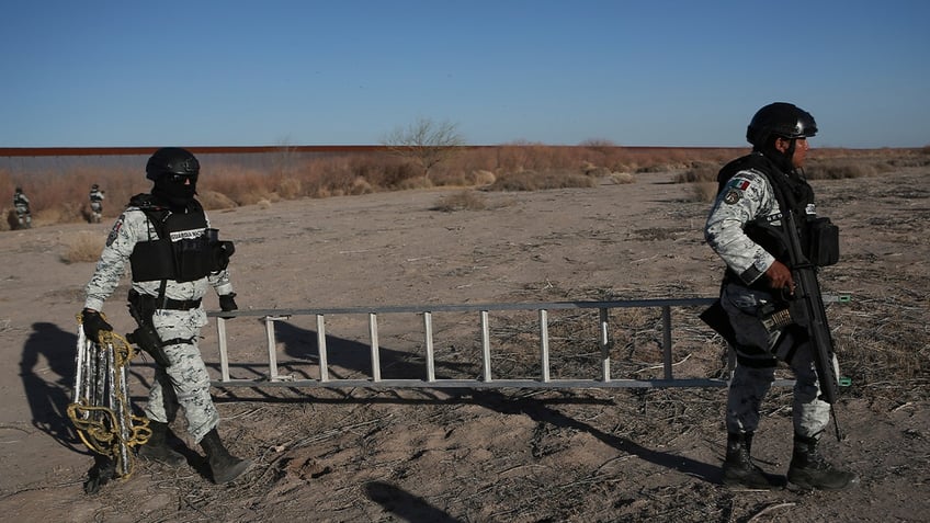 Mexican service members moving ladder