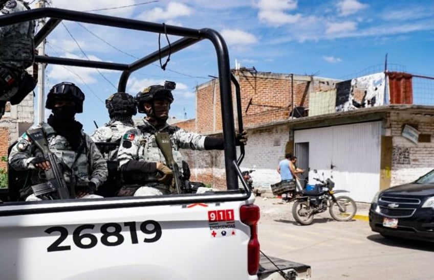 National Guard members patrol outside a rehabilitation center where gunmen killed four peo