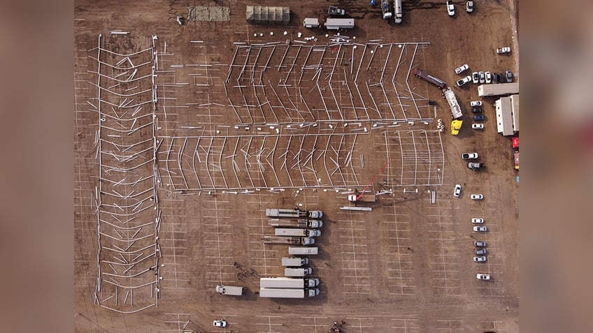 Long metal braces are laid out where temporary shelters for migrants will be built in Mexico, an aerial view