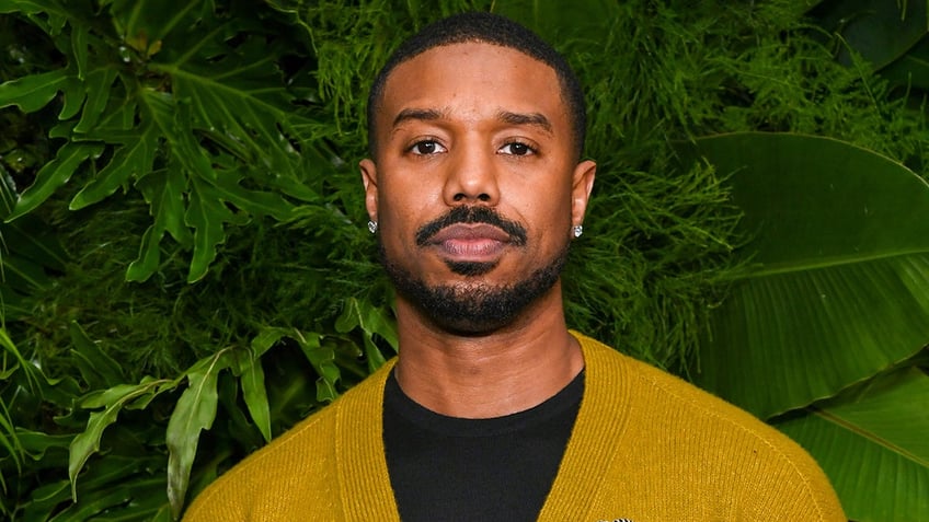 Michael B. Jordan attends red carpet wearing a mustard yellow Chanel cardigan