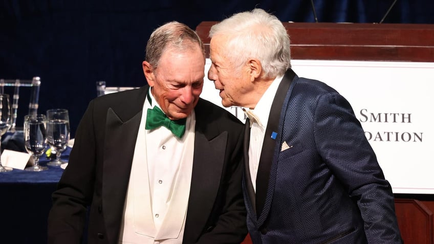 Mayor Mike Bloomberg, left, and New England Patriots owner Robert Kraft converse during the annual Alfred E. Smith Foundation Dinner at the New York Hilton Midtown on Oct. 17, 2024 in New York City.