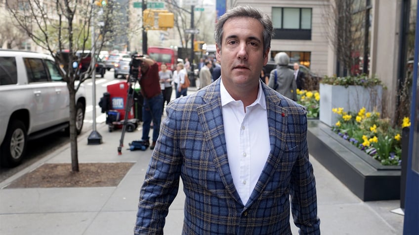 Michael Cohen walking down the sidewalk.