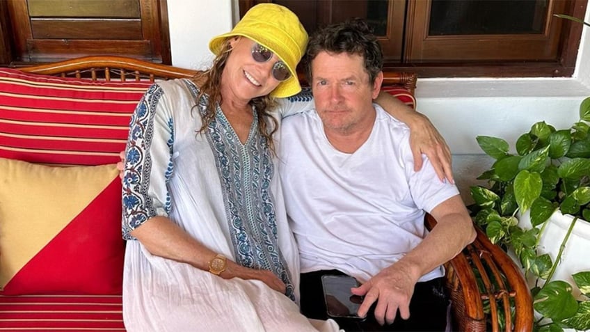 Tracy Pollan and Michael J Fox cuddling outside