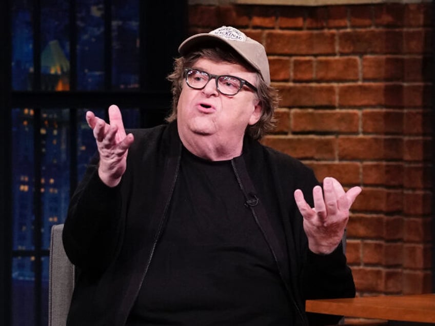 LATE NIGHT WITH SETH MEYERS -- Episode 863 -- Pictured: (l-r) Filmmaker Michael Moore duri