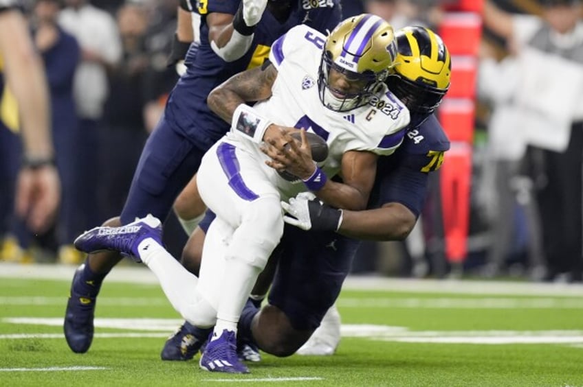 Michigan defensive lineman Kenneth Grant sacks Washington quarterback Michael Penix Jr. during the first half of the national championship NCAA College Football Playoff game Monday, Jan. 8, 2024, in Houston.(AP Photo/Eric Gay)