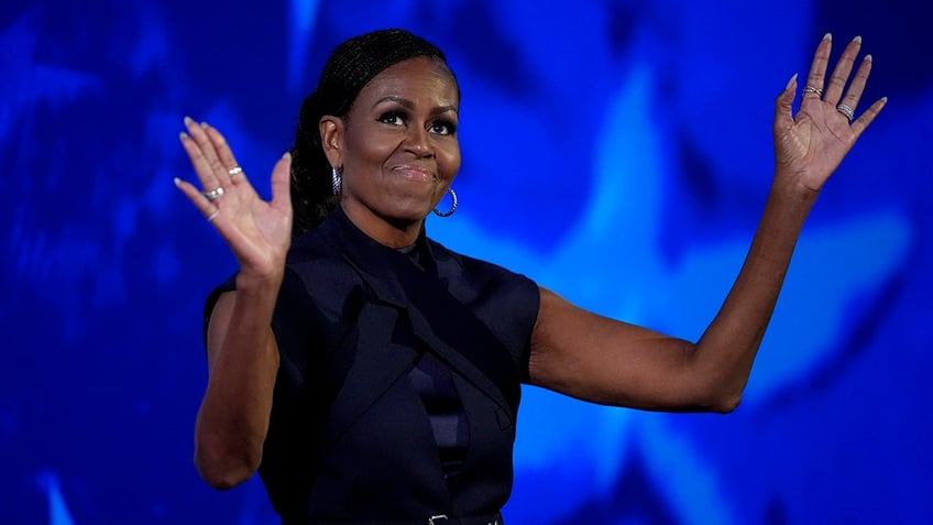 Michelle Obama raising hands at DNC speech