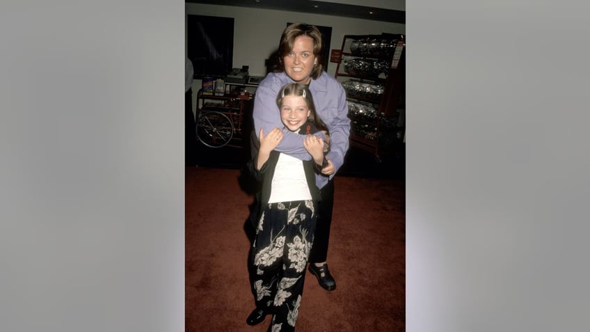 Rosie O'Donnell hugging Michelle Trachtenberg in 19996