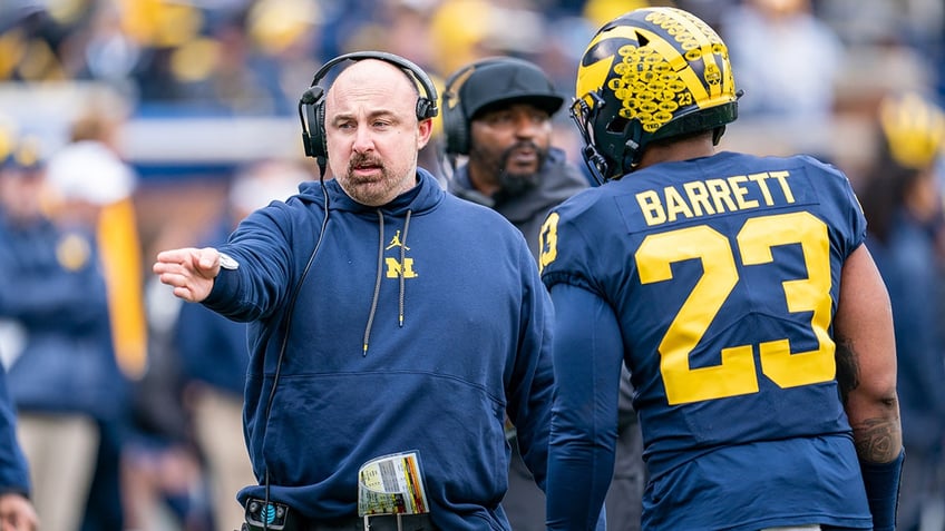 michigan assistant coach chris partridge dismissed just one day after jim harbaugh accepts three game ban