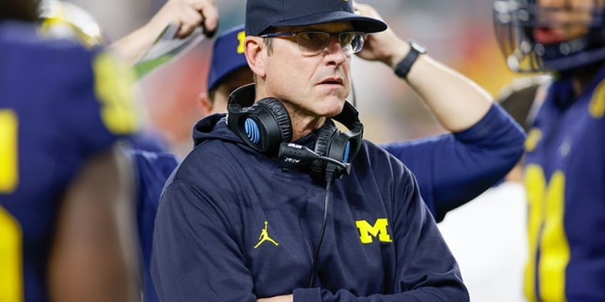 michigan coach jim harbaughs suspension falls through hes likely to coach all season report