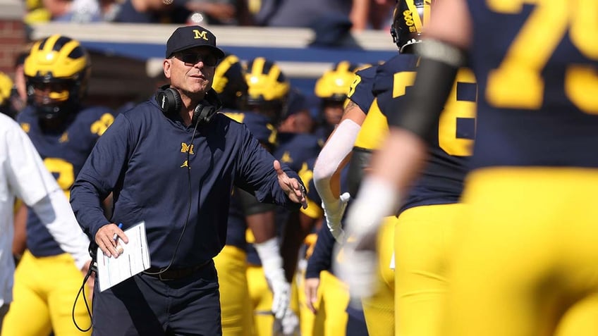 michigan overcomes slow start to defeat rutgers in jim harbaughs return from 3 game suspension