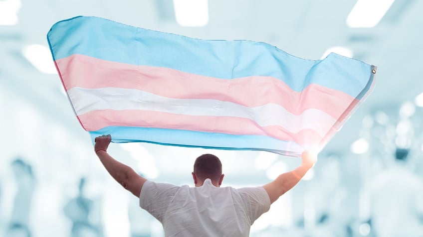 Person holding transgender flag