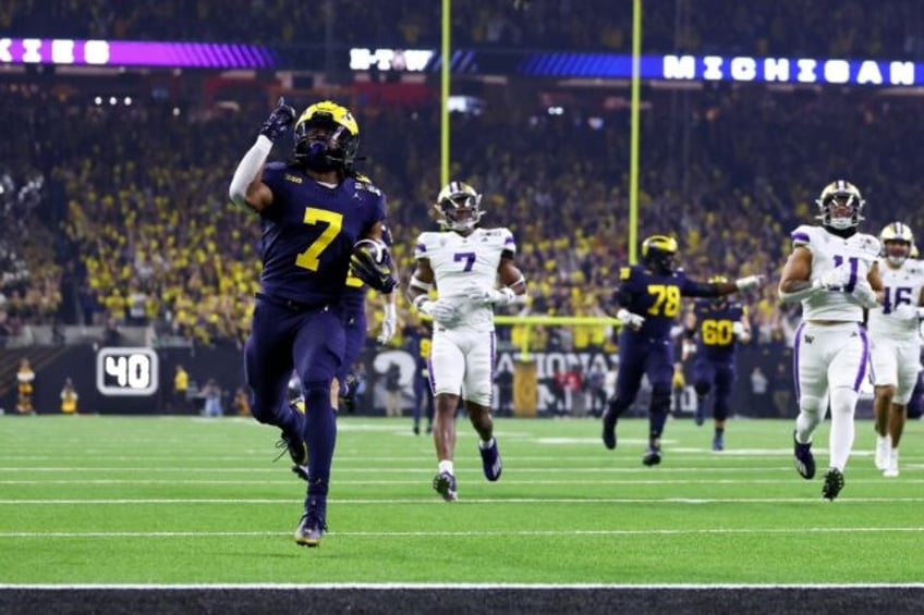 Donovan Edwards reacts as he scores one of two first quarter touchdowns in Michigan's college football championship win over Washington on Monday