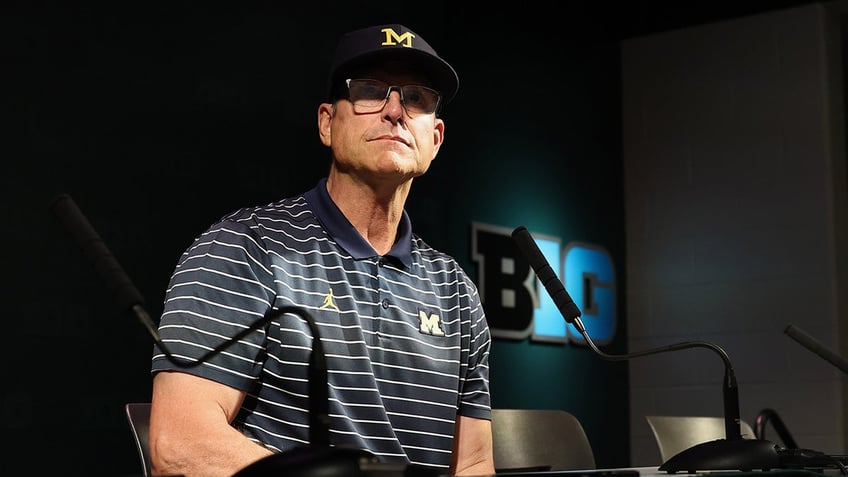 Jim Harbaugh speaks at a press conference