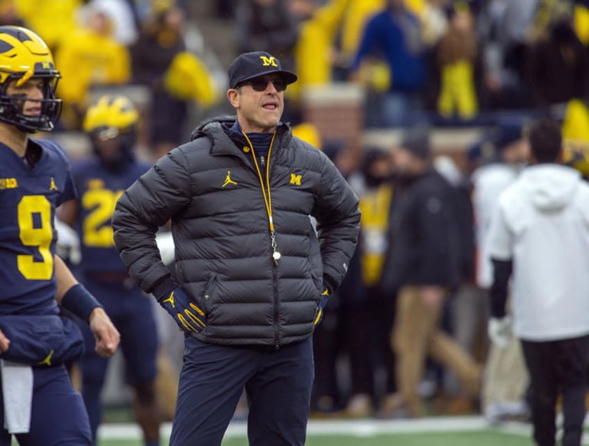 michigans jim harbaugh says he would take less salary if it meant college athletes would be paid