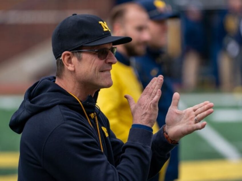 michigans jim harbaugh says he would take less salary if it meant college athletes would be paid